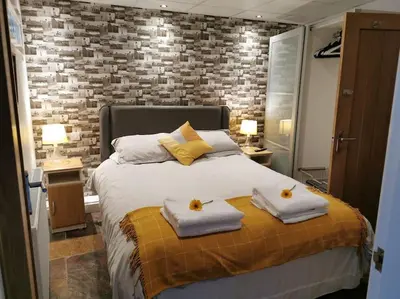 a bedroom with a bed with towels on it at Private garden apartment with secure parking in Southport