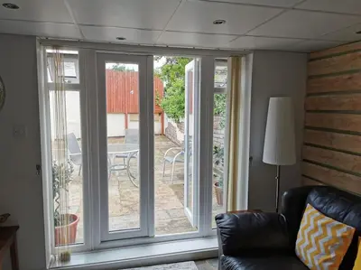a living room with a sliding glass door to a patio at Private garden apartment with secure parking in Southport