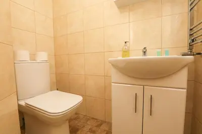 a bathroom with a toilet and a sink at Luxe Retreat - Steps from Stadium - Pool Table, Ping Pong, Football Table in Liverpool
