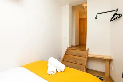 a room with a bed and a chair and a table at Luxe Retreat - Steps from Stadium - Pool Table, Ping Pong, Football Table in Liverpool