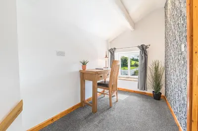 a room with a desk and a window at The Black Dog Apartment in Dalton in Furness
