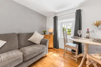 a living room with a couch and a table at The Black Dog Apartment in Dalton in Furness
