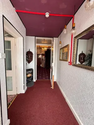 a hallway with a purple ceiling and a red carpet at OYO Delton Hotel Blackpool Pleasure Beach in Blackpool