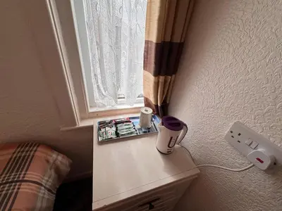 a corner of a room with a table with a window at OYO Delton Hotel Blackpool Pleasure Beach in Blackpool