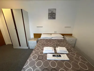 a bedroom with a bed with towels on it at OYO Delton Hotel Blackpool Pleasure Beach in Blackpool