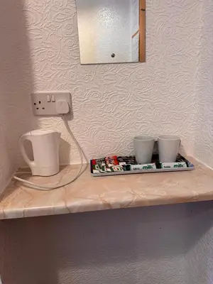 a shelf with two cups on top of it at OYO Delton Hotel Blackpool Pleasure Beach in Blackpool