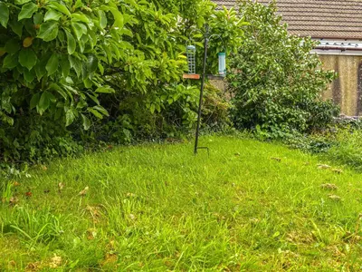 a bird feeder in the grass in a yard at Kiln Cottage in Bolton le Sands