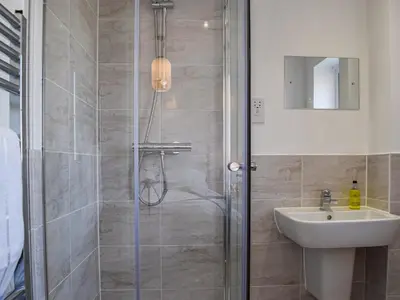 a bathroom with a shower and a sink at The Goldsmith in Blackpool