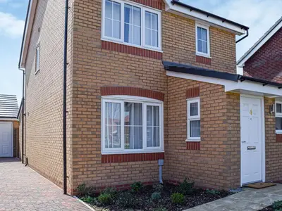 a brick house with a white door and windows at The Goldsmith in Blackpool