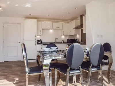 a kitchen and dining room with a table and chairs at The Goldsmith in Blackpool