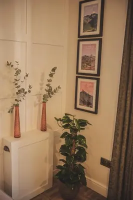 a room with three vases and a plant on a wall at The Coach House Heysham in Heysham