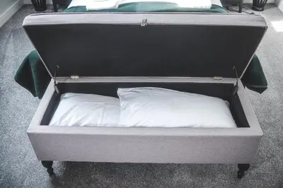 a small bed with a white pillow in it at The Coach House Heysham in Heysham