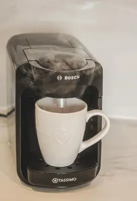 a toaster with a cup of coffee in it at The Coach House Heysham in Heysham