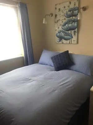 a bed with blue pillows sitting in a bedroom at Marlow Lodge in Blackpool