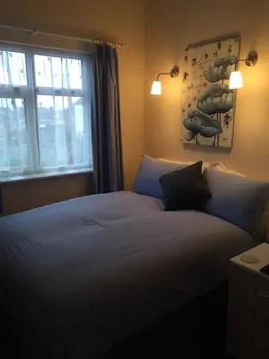 a bedroom with a large bed with a window at Marlow Lodge in Blackpool