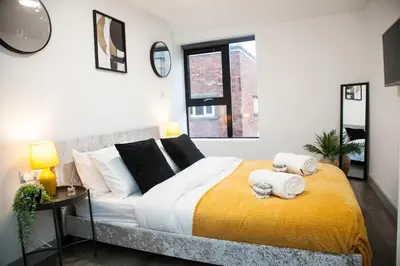 a bedroom with a large bed with towels on it at Modern 1-Bedroom Liverpool Apartment, Cosy & Fast Wi-Fi in Liverpool
