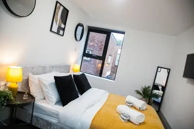 a bedroom with a bed with towels on it at Modern 1-Bedroom Liverpool Apartment, Cosy & Fast Wi-Fi in Liverpool
