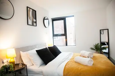 a bedroom with a bed with towels on it at Modern 1-Bedroom Liverpool Apartment, Cosy & Fast Wi-Fi in Liverpool