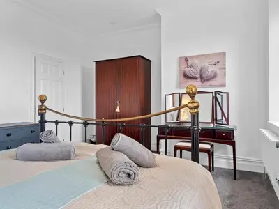 a bedroom with a bed and a desk in it at Mulberry Beautiful Apartment with Sea View - Pass the Keys in Grange Over Sands