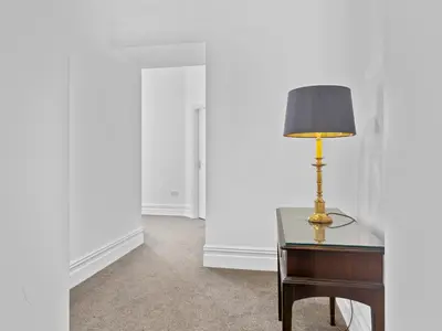 a lamp sitting on a desk in a room at Mulberry Beautiful Apartment with Sea View - Pass the Keys in Grange Over Sands