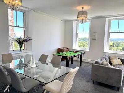 a living room with a ping pong table at Mulberry Beautiful Apartment with Sea View - Pass the Keys in Grange Over Sands