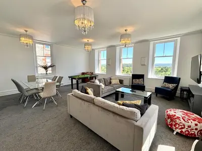 a living room with a couch and a table at Mulberry Beautiful Apartment with Sea View - Pass the Keys in Grange Over Sands