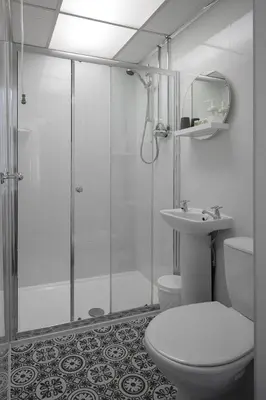 a bathroom with a shower and a toilet and a sink at The Wescoe Guesthouse in Blackpool