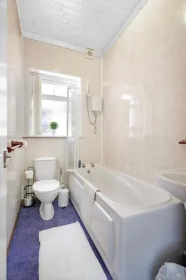a bathroom with a tub and a toilet and a sink at SuiteSpot Serviced Apartments Blackpool in Blackpool