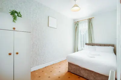 a bedroom with a white bed and a window at SuiteSpot Serviced Apartments Blackpool in Blackpool