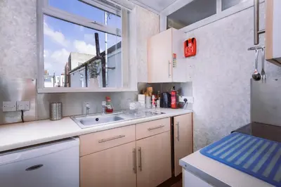 a kitchen with a sink and a window at SuiteSpot Serviced Apartments Blackpool in Blackpool