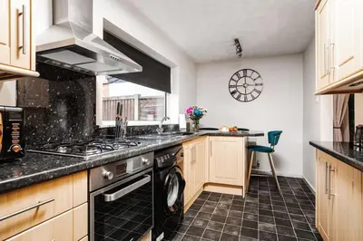 a kitchen with a stove and a dishwasher at Alexandra - WiFi Parking Garden in Walton le Dale