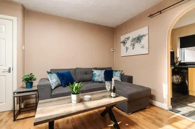 a living room with a couch and a table at Alexandra - WiFi Parking Garden in Walton le Dale