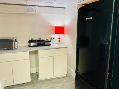 a kitchen with a red lamp on a counter at The Danescourt in Blackpool