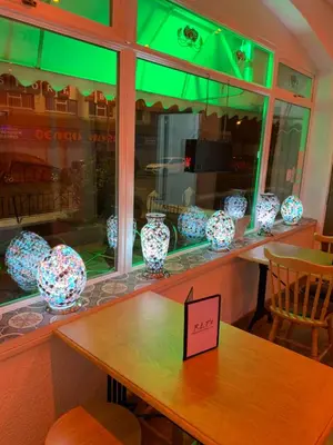 a table with blue and white vases in a window at The Danescourt in Blackpool