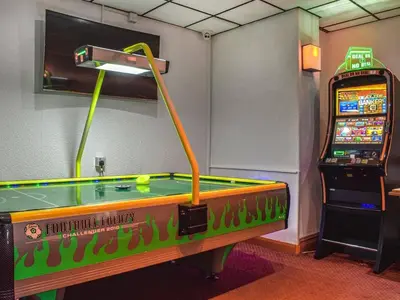 a room with a pool table and a video game at The Danescourt in Blackpool