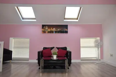 a living room with a couch and two skylights at Liverpool City Stays - Bold Street in Liverpool