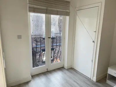 an empty room with a large window and a door at Liverpool City Stays - Bold Street in Liverpool