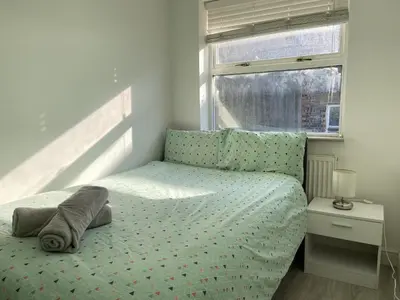 a small bedroom with a bed with a window at Liverpool City Stays - Bold Street in Liverpool