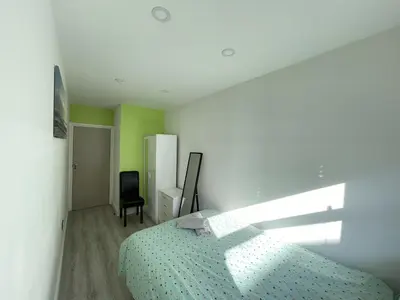 a white bedroom with a bed and a chair at Liverpool City Stays - Bold Street in Liverpool