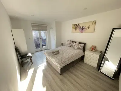 a bedroom with a bed and a mirror and a chair at Liverpool City Stays - Bold Street in Liverpool