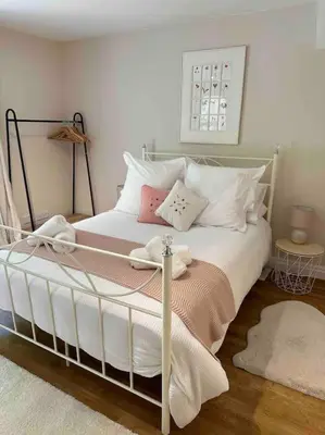 a bedroom with a white bed with pillows at Leafy lodge in Lytham in Brown Moss Side