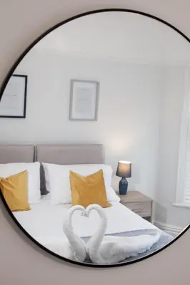 two swans forming a heart in a bedroom mirror at 8 Karslake Road in Wallasey