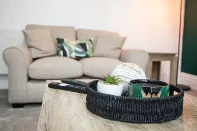 a coffee table with a basket on top of a couch at 8 Karslake Road in Wallasey