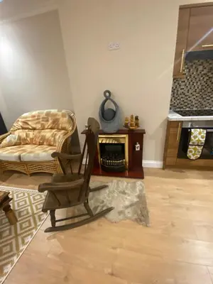 a living room with a chair and a fireplace at 2 Bedroom New Flat In Blackpool Town Center in Blackpool