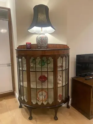 a lamp on top of a dresser next to a television at 2 Bedroom New Flat In Blackpool Town Center in Blackpool