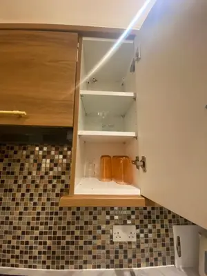 a cupboard in a kitchen with utensils at 2 Bedroom New Flat In Blackpool Town Center in Blackpool