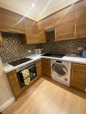 a kitchen with a washer and a washing machine at 2 Bedroom New Flat In Blackpool Town Center in Blackpool