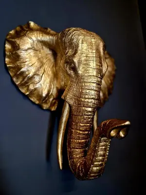 a gold elephant head hanging on a wall at The Hamilton - The Studio luxury holiday let's in Scorton