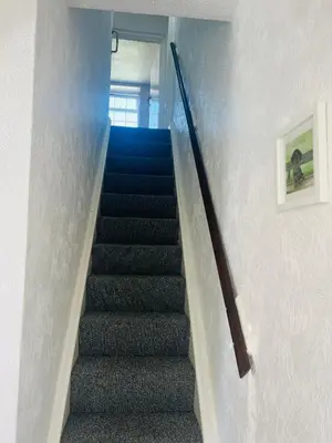 a staircase in a house with a stair case at Willow Cottage - Billinge Wigan, sleeps 4 , parking and garden in Billinge
