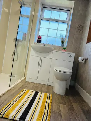 a bathroom with a sink and a toilet and a shower at Willow Cottage - Billinge Wigan, sleeps 4 , parking and garden in Billinge